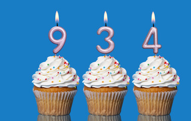 Birthday Cupcakes With Candles Lit Forming The Number 934