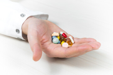 Young doctor in blue gloves, checking pills on a list. Close-up. Slow motion.