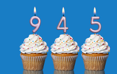 Birthday Cupcakes With Candles Lit Forming The Number 945