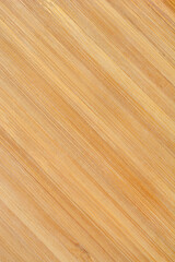A light brown bamboo cutting board with visible grain and fibers