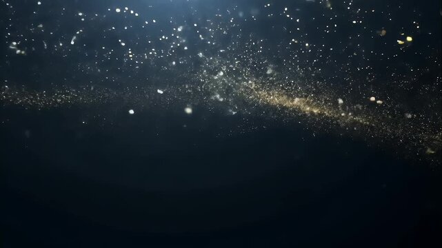 Shiny particles drifting in weightless motion, creating a starlit effect on a black background