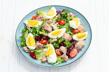 Canned Tuna salad with eggs and tomatoes photography . Top view