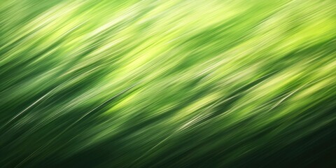 Obraz premium Abstract green grass backdrop with smooth motion blur effect showcasing varying shades of green, creating a serene natural atmosphere.