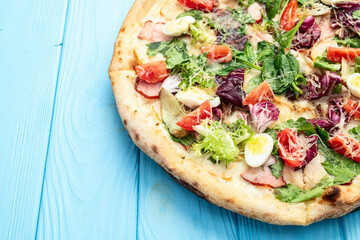 Italian pizza caesar with eggs salad chicken tomatoes and mozzarella photography. top view
