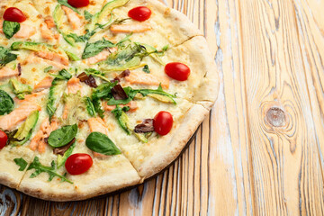 Italian pizza with avocado salmon  tomatoes and mozzarella photography. top view