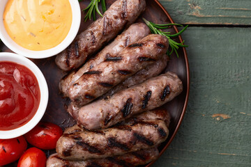 Grilled beef sausages with rosemary sauce and tomatoes photography . Top view