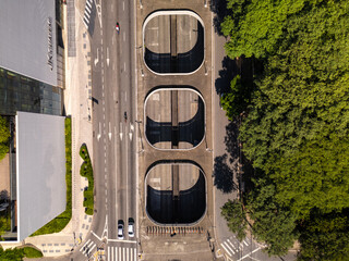 top down view of a street and a tunnel in Sao Paulo city in Brazil with green trees on the side 