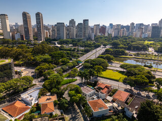 aerial view of Sao Paulo city in Brazil with a park, buildings, and Pinheiros river crossing the city. Marginal Pinheiros avenue with traffic during daylight