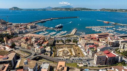 Obraz premium Aerial view of the marina located in Pozzuoli, near Naples, Italy.In background are the Tyrrhenian Sea and the promontory of Capo Miseno.