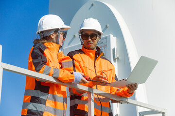Engineer workers teamwork working together service maintenance wind turbine clean power green energy © Quality Stock Arts