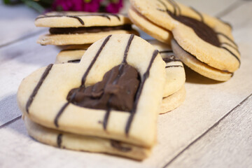 Cookies in the face of a heart for Valentine's Day with a flower in the background