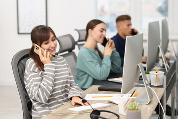 Sales department. People calling to clients in office, selective focus