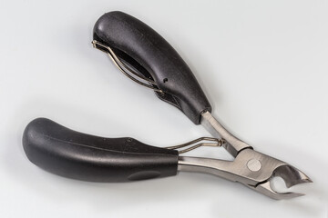 Obraz premium Professional pedicure nail clipper with curved blades on gray background