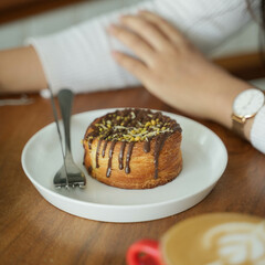 Close up photography of young beautiful Asian women ready to enjoying cake at coffee shop.