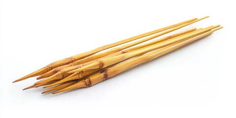 Bamboo skewers arranged in a fan shape with pointed ends on a bright white background showcasing their natural wood tones and textures.