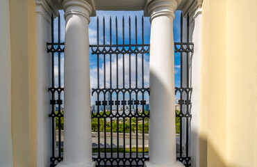 A stone wall with columns and a lattice.