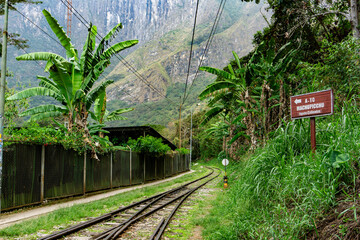 Majestic view of the railway to Machu Picchu surrounded by vibrant green nature in amazonian forest in sacred valley Peru