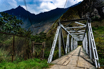 Fototapeta premium Hydroelectric entrance trail in amazonic forest surrounded by mountains in the way to Machu Picchu in Peru