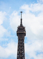 Detailed view of the top part of the famous Eiffel Tower in Paris, France