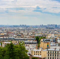 Parisian neighborhood with the different roof styles in the summer sun .