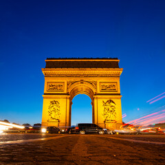 Arc de Triomphe at night. View from Avenue des Champs-Elysees, Paris, France.