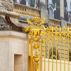 Versailles royal castle golden gate detail. Gilded historical golden castle gate.