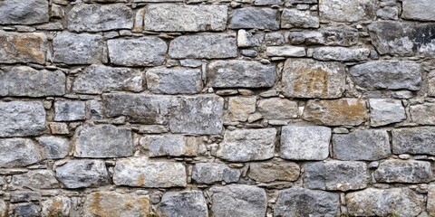 Fototapeta premium Textured stone wall background featuring gray and brown stones arranged in a horizontal pattern suitable for various design applications