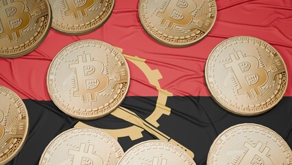 Several bitcoins are laid out on the flag of Angola