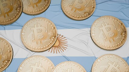 Several bitcoins are laid out on the flag of Argentina