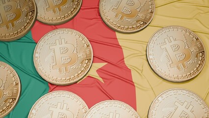 Several bitcoins are laid out on the flag of Cameroon