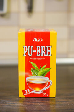Vertical shot of a Polish Astra Pu Erh tea in a box on a wooden surface in the kitchen