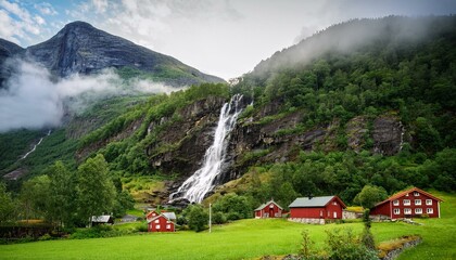 a tall waterfall in a lush green mountainside in the flamsdalen valley vestland county norway the waterfall flows near several houses nestled at the foot surrounded by dense forest and vegetation
