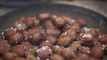 Cooking traditional street food, marrons, roasting marron