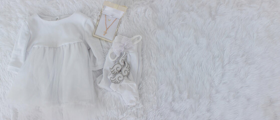 Obraz premium clothes for a girl's baptism and a chain and a cross. Orthodox. baptism