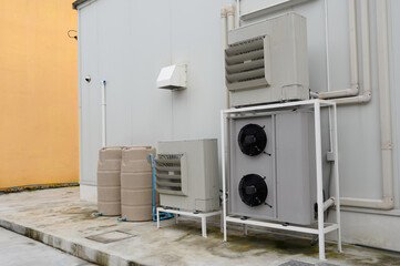 Air compressor or air condenser unit located on support outside building to heat released transferred to surrounding environment, Compressor is part of cooling function and air conditioning HVAC syste