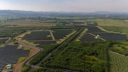Fototapeta premium Aerial bird view photo of photovoltaic power station also known as a solar park is large-scale photovoltaic system (PV system) designed for the supply of merchant power into the electricity grid