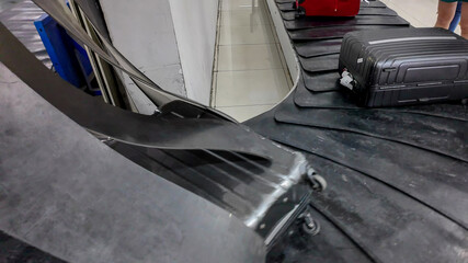 Airport luggage carousel with suitcases, highlighting travel, airline baggage handling, and...