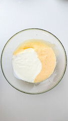 A glass bowl of thick pancake batter ready for mixing, perfect for a cozy weekend breakfast or Shrove Tuesday celebration