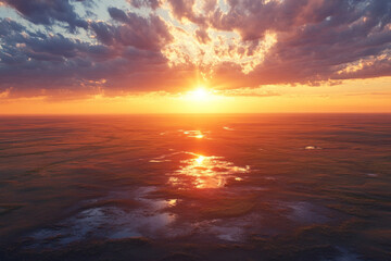 Obraz premium Vivid sunset paints the sky over the ocean, casting golden hues on rippling water and soft clouds, creating a serene and breathtaking scene.
