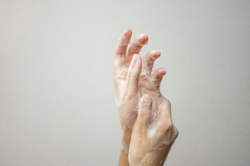 Washing hands with soap on a white background. Hygiene concept.