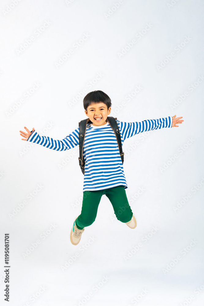 Fototapete ジャンプ、子供、男の子、小学生、ランドセル、バンザイ、飛び出す、元気、アクティブ、笑顔、全身、カメラ目線、飛躍、飛ぶ、躍動感、アクション、挑戦、チャレンジ、成長、目標、ポジティブ、やる気、喜ぶ、嬉しい、楽しい、ダンス、カジュアル、活発、放課後、遊ぶ、健康、はねる、飛び跳ねる、日本人、キッズ、児童、学習、勉強、教育、通学、男子、少年、広告、切り抜き、白バック、コピースペース、ファッション、おしゃれ、
