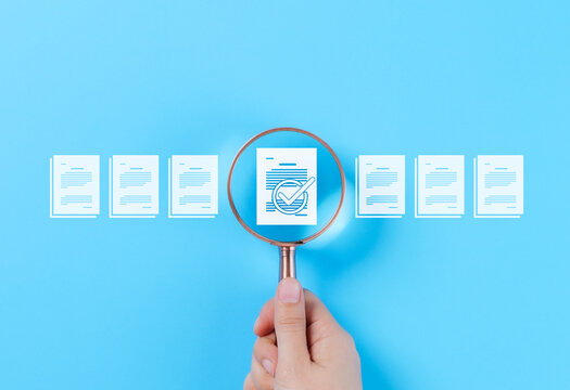 Document Review and Quality Control Process Concept. A hand holding a magnifying glass focuses on a document with a checkmark, document review, and approval processes. Certificate management, Audit,
