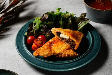 slice of Beef Meat Pie with a flaky puff pastry double crust with hearty minced beef cooked with vegetables and seasoning. Kimchi Beef Meat Pie crunchy and toothy