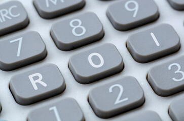 Fototapeta premium ROI representing Return On Investment letter on calculator button