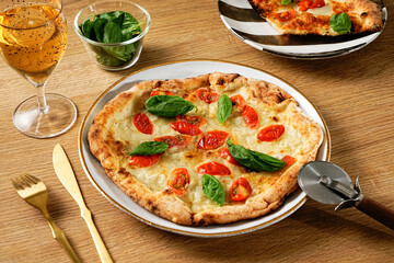 Neapolitan-style pizza. Pizza Margherita thin crust, fresh ingredients, and high edges. Pizza Napoletana