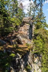 Hill summit with quartzite rock formation and trees - Jeleni hrbet in Jeseniky mountains in Czech republic