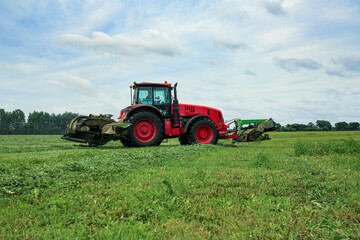 Obraz premium tractor. haying. harvesting grass. farming