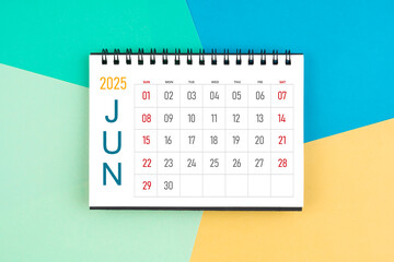 June 2025 month blank desk calendar on colorful background.