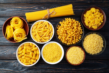 Assorted Uncooked Pasta in Bowls on Wooden Table