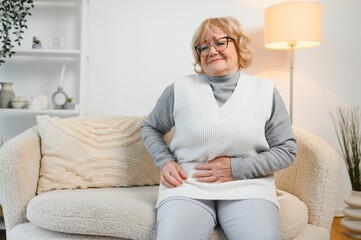 Elderly senior woman stomach ache illness, food poisoning in patient with bacterial infection. Unhappy old painful on stomach vomit and tired need medicine and rest